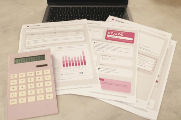 Bills, calculator, and a laptop: financial tasks underway
